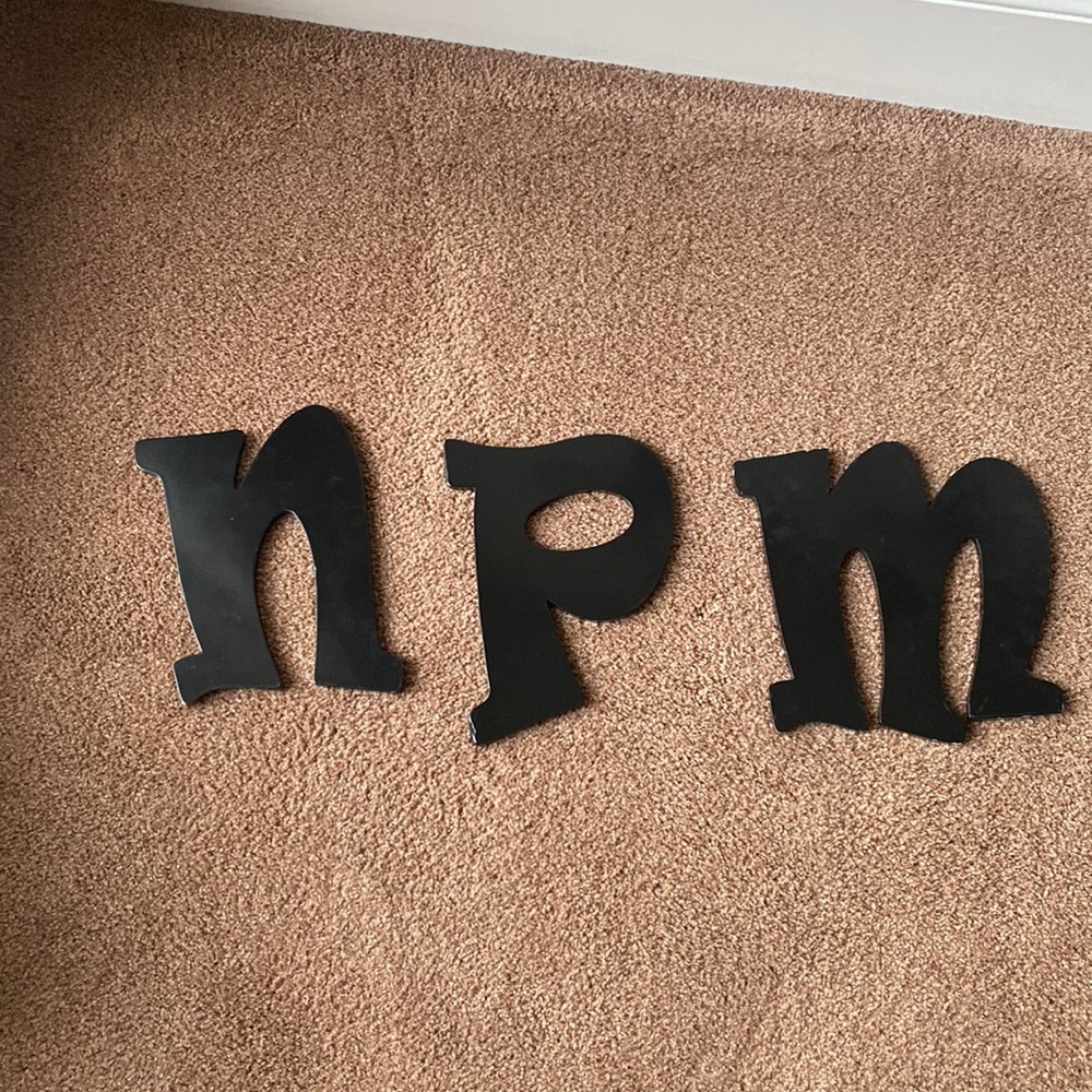 Black flat letters N M P, one of each